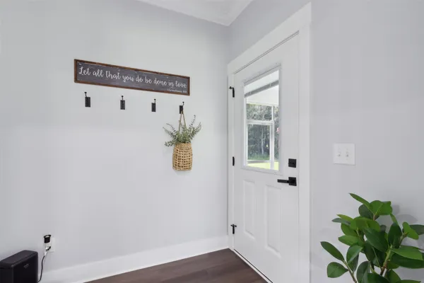 a spacious bathroom with double vanity a mirror a bathtub and windows