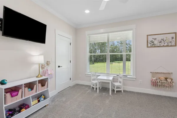 a spacious bedroom with a bed and a refrigerator