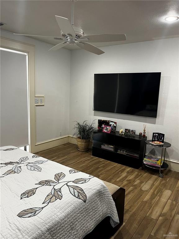 406 Rio Grande Drive Mission, TX 78572 - Photo 13 of 27 Bedroom featuring dark wood finished floors and ceiling fan