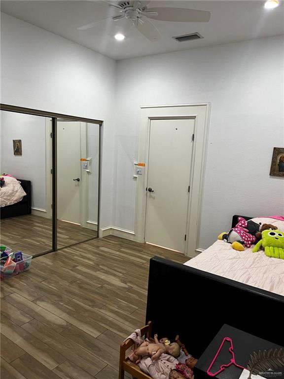 406 Rio Grande Drive Mission, TX 78572 - Photo 16 of 27 Bedroom with dark wood finished floors, recessed lighting, a ceiling fan, and a closet