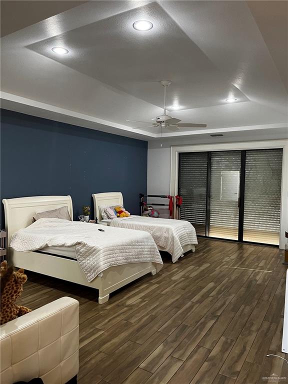 406 Rio Grande Drive Mission, TX 78572 - Photo 17 of 27 Bedroom featuring dark wood finished floors, ceiling fan, recessed lighting, and a tray ceiling