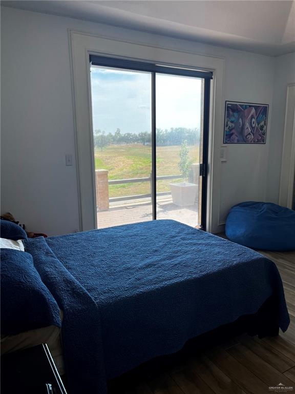 406 Rio Grande Drive Mission, TX 78572 - Photo 22 of 27 Bedroom featuring access to outside and wood finished floors