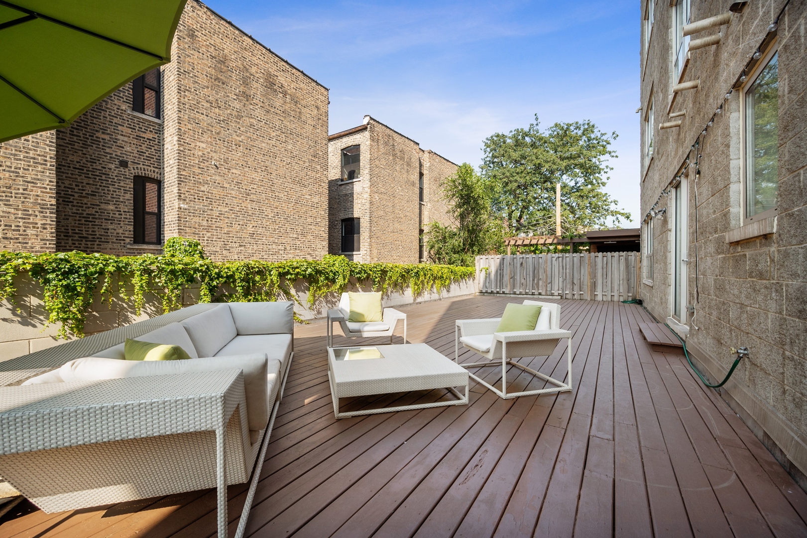 1850 West Division Street, Unit 2E Chicago, IL 60622 - Photo 19 of 22 a view of a house with wooden deck and furniture