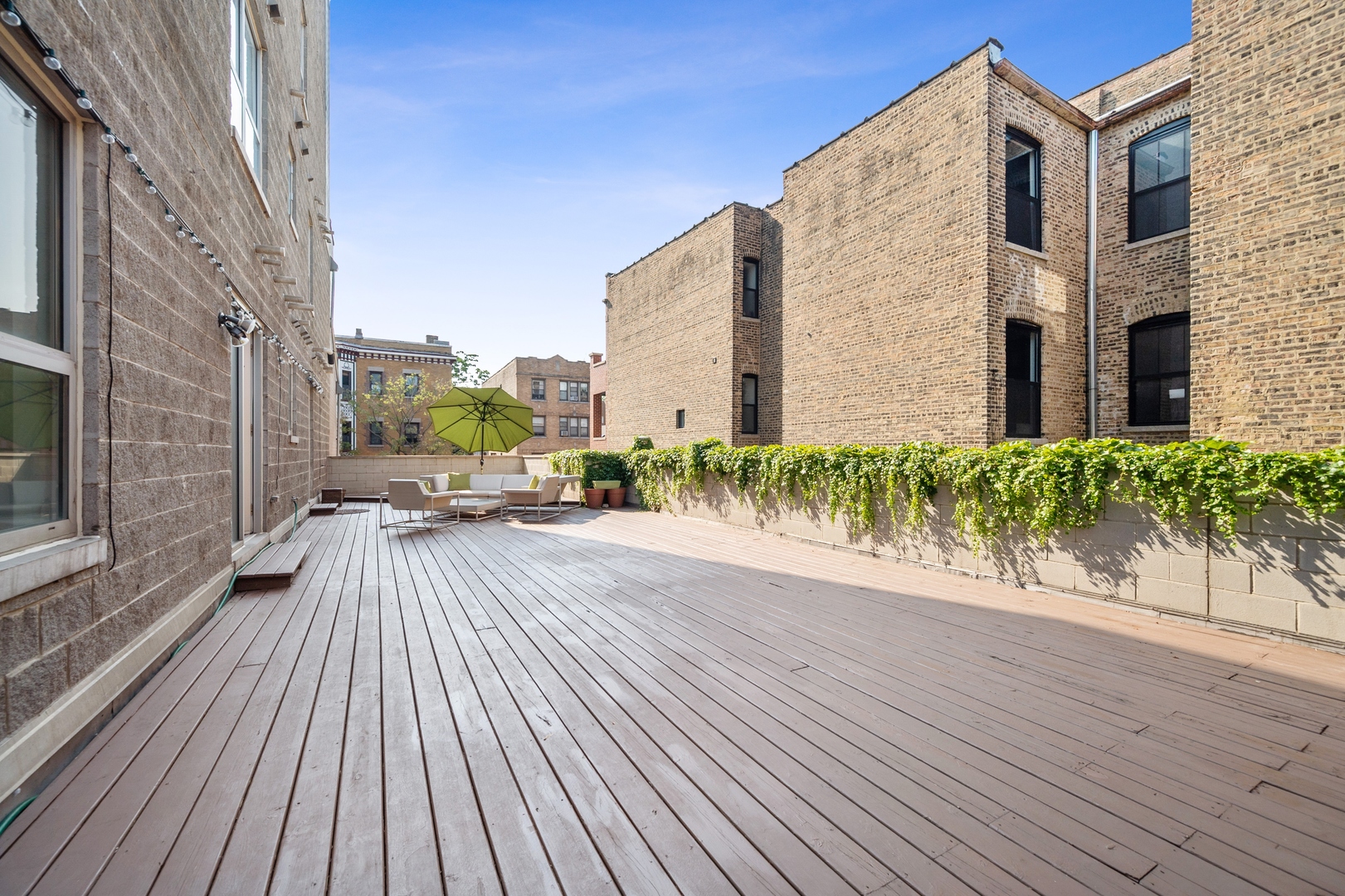 1850 West Division Street, Unit 2E Chicago, IL 60622 - Photo 21 of 22 a view of a balcony with wooden floor