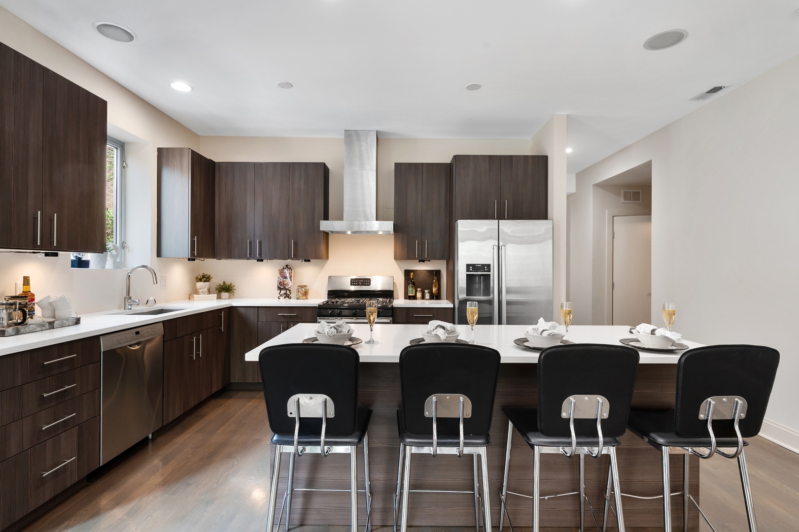 1850 West Division Street, Unit 2E Chicago, IL 60622 - Photo 9 of 22 a kitchen with lots of white cabinets appliances and a dining table