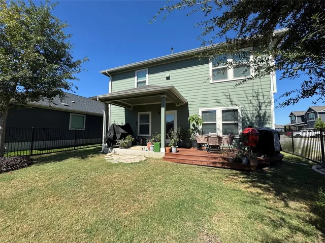 a view of a house with backyard porch and sitting area