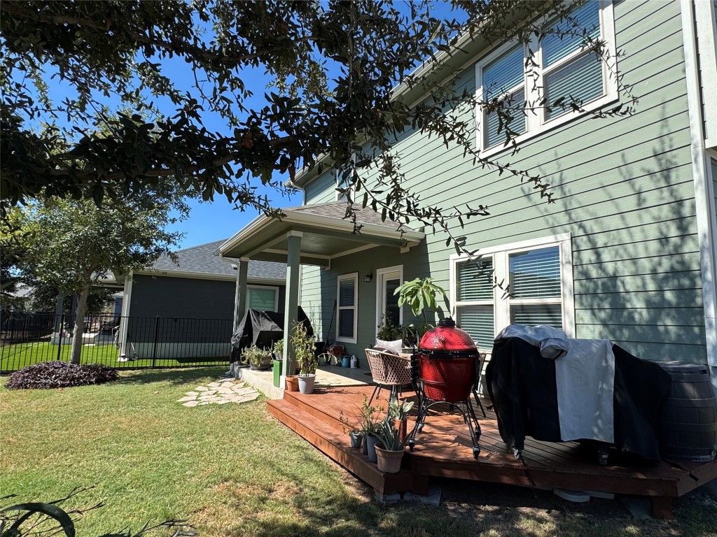 247 Simon Kyle, TX 78640 - Photo 18 of 23 a view of a patio with table and chairs under an umbrella