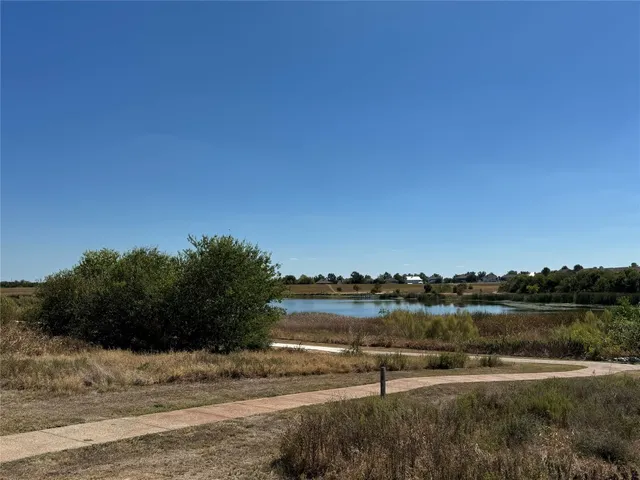 a view of a lake with houses in the back