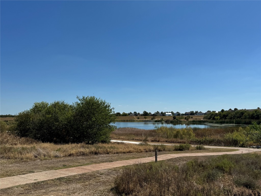 247 Simon Kyle, TX 78640 - Photo 23 of 23 a view of a lake with houses in the back