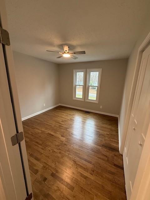 2801 Kellogg Creek Road Acworth, GA 30102 - Photo 15 of 28 a view of empty room with wooden floor and fan