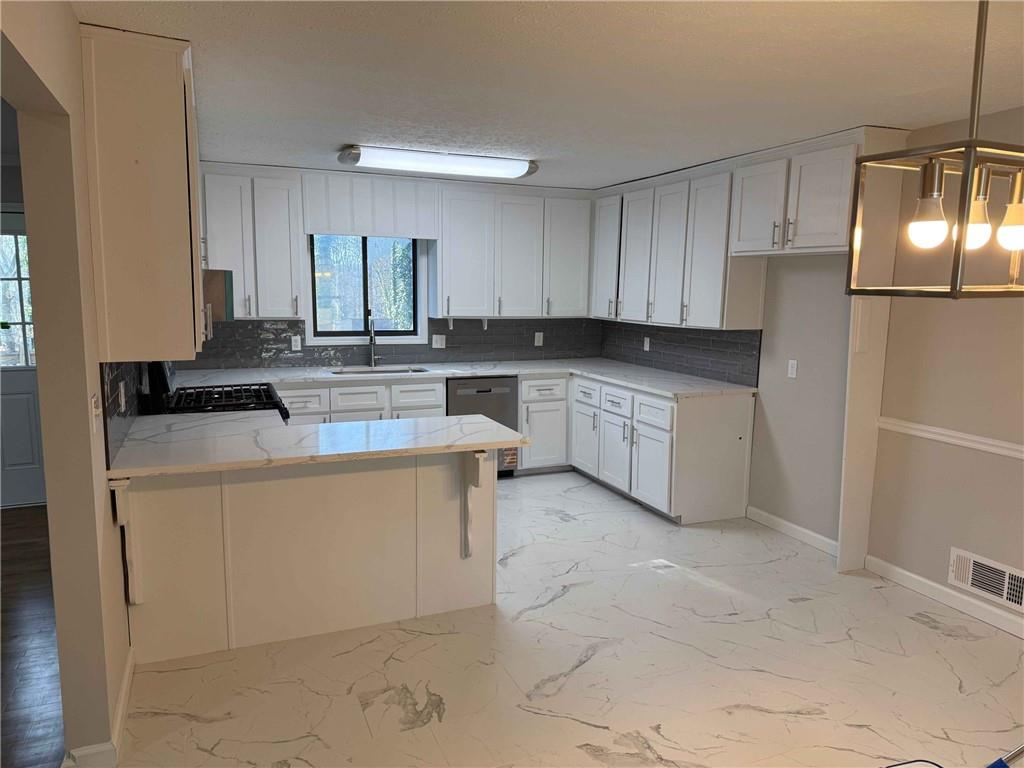 2801 Kellogg Creek Road Acworth, GA 30102 - Photo 10 of 28 a kitchen with stainless steel appliances granite countertop a sink stove and refrigerator