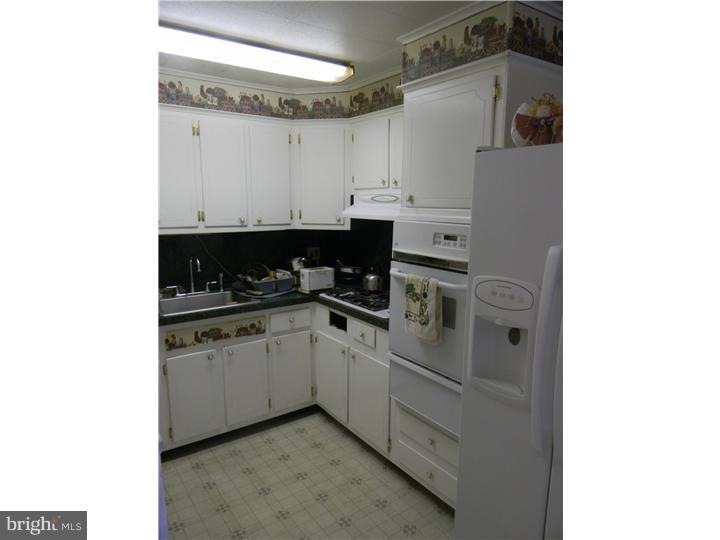 1925 Carter Road Folcroft, PA 19032 - Photo 12 of 25 a kitchen with a white cabinets and white appliances