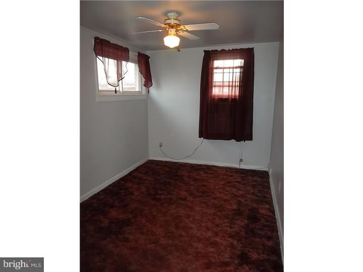 1925 Carter Road Folcroft, PA 19032 - Photo 21 of 25 a view of an empty room with window and chandelier fan