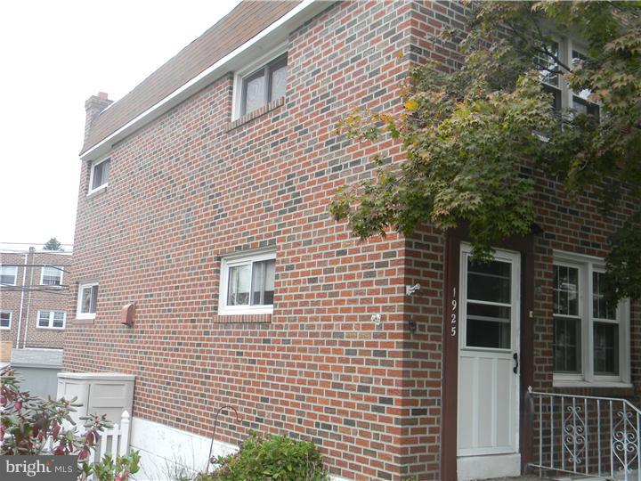 1925 Carter Road Folcroft, PA 19032 - Photo 4 of 25 a view of a brick house with many windows