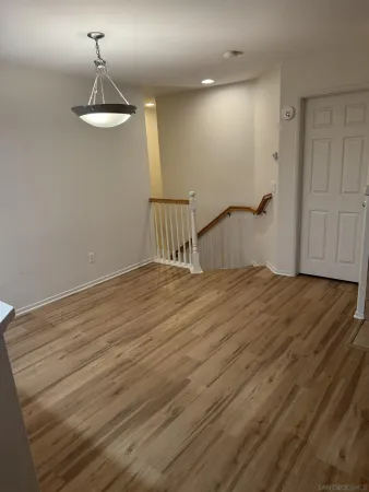 a room with a bed and wooden floor