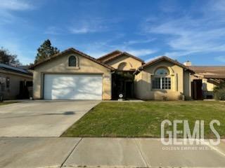Undisclosed Address Bakersfield, CA 93313 - Photo 1 of 18 a front view of a house with a garden