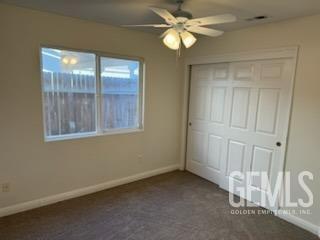 Undisclosed Address Bakersfield, CA 93313 - Photo 8 of 18 an empty room with a ceiling fan and a window