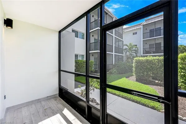 a view of a patio with couches table and chairs and potted plants