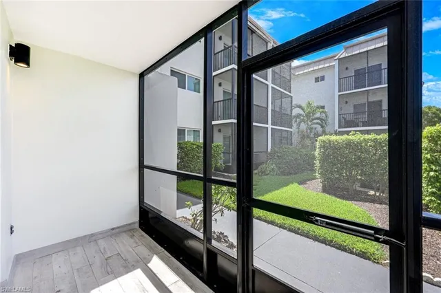 a view of a patio with couches table and chairs and potted plants