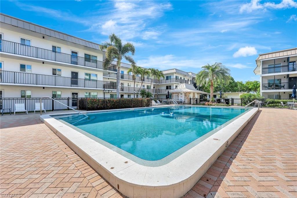 766 Central Avenue, Unit 117 Naples, FL 34102 - Photo 20 of 25 a view of swimming pool from a balcony