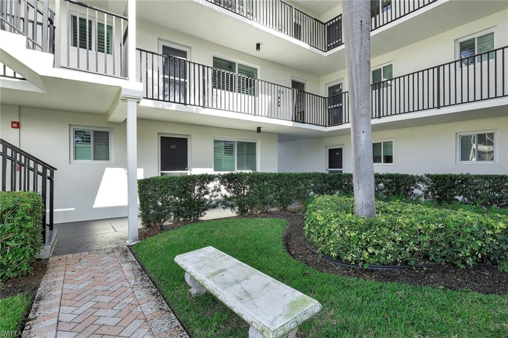 766 Central Avenue, Unit 117 Naples, FL 34102 - Photo 25 of 25 a front view of a house with garden