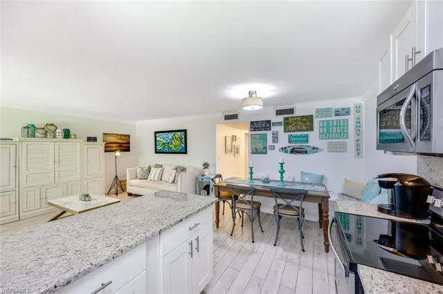 a view of a kitchen with granite countertop lots of counter top space and furniture