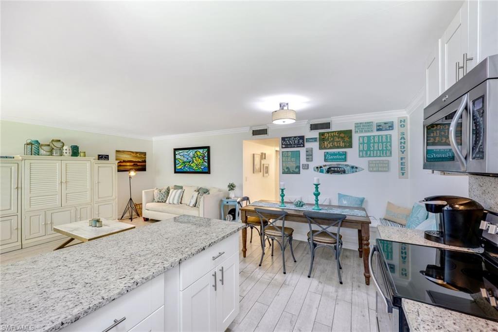 766 Central Avenue, Unit 117 Naples, FL 34102 - Photo 7 of 25 a view of a kitchen with granite countertop lots of counter top space and furniture