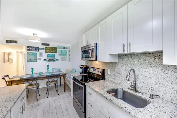 a kitchen with a sink cabinets and window