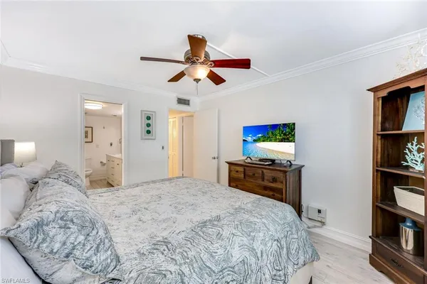 a bedroom with a bed and a book shelf
