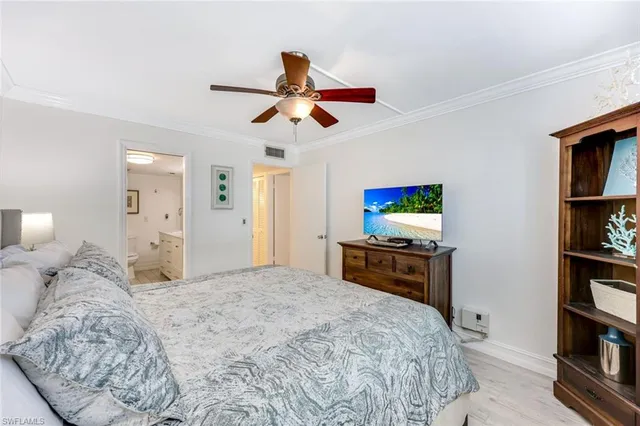 a bedroom with a bed and a book shelf