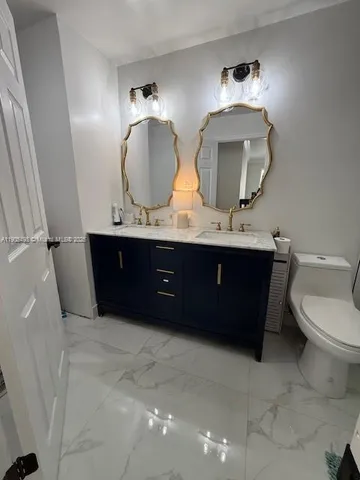 a bathroom with a double vanity sink and a mirror