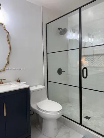 a bathroom with a toilet sink and shower