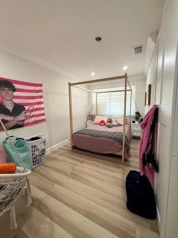a bedroom with a bed and a walk in closet
