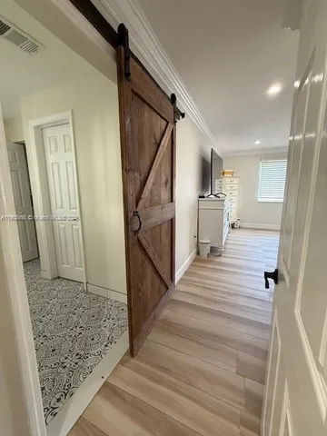 a view of entryway and hall with wooden floor