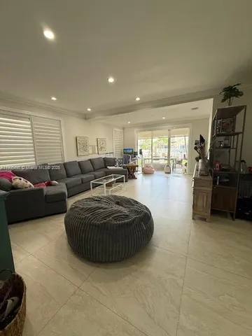 a living room with furniture a couch and a flat screen tv