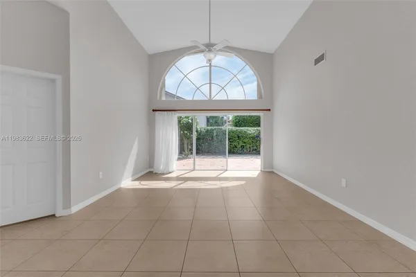 an empty room with windows and outdoor view