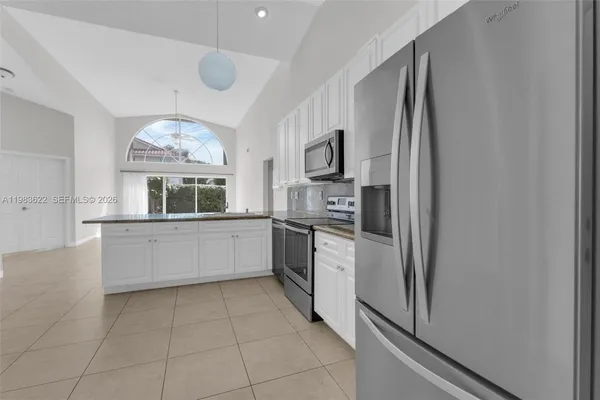 a kitchen with stainless steel appliances a refrigerator sink and microwave