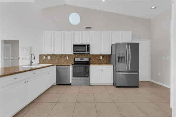 a kitchen with a refrigerator sink and microwave