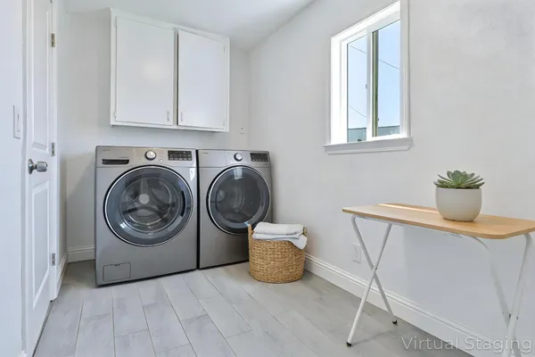 a view of a storage and utility room with washer and dryer