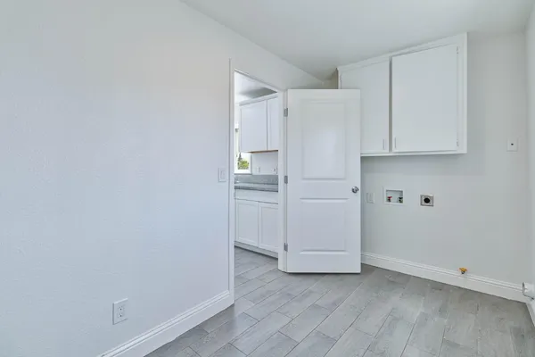 a view of cabinets and utility room with racks