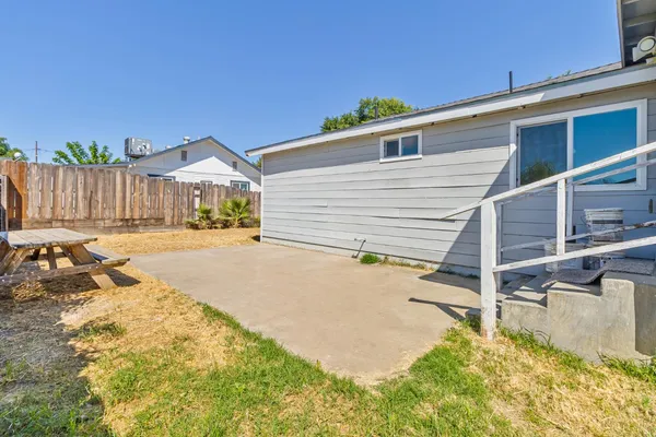 a view of backyard of house and wooden deck