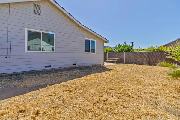 a view of house with backyard and trees
