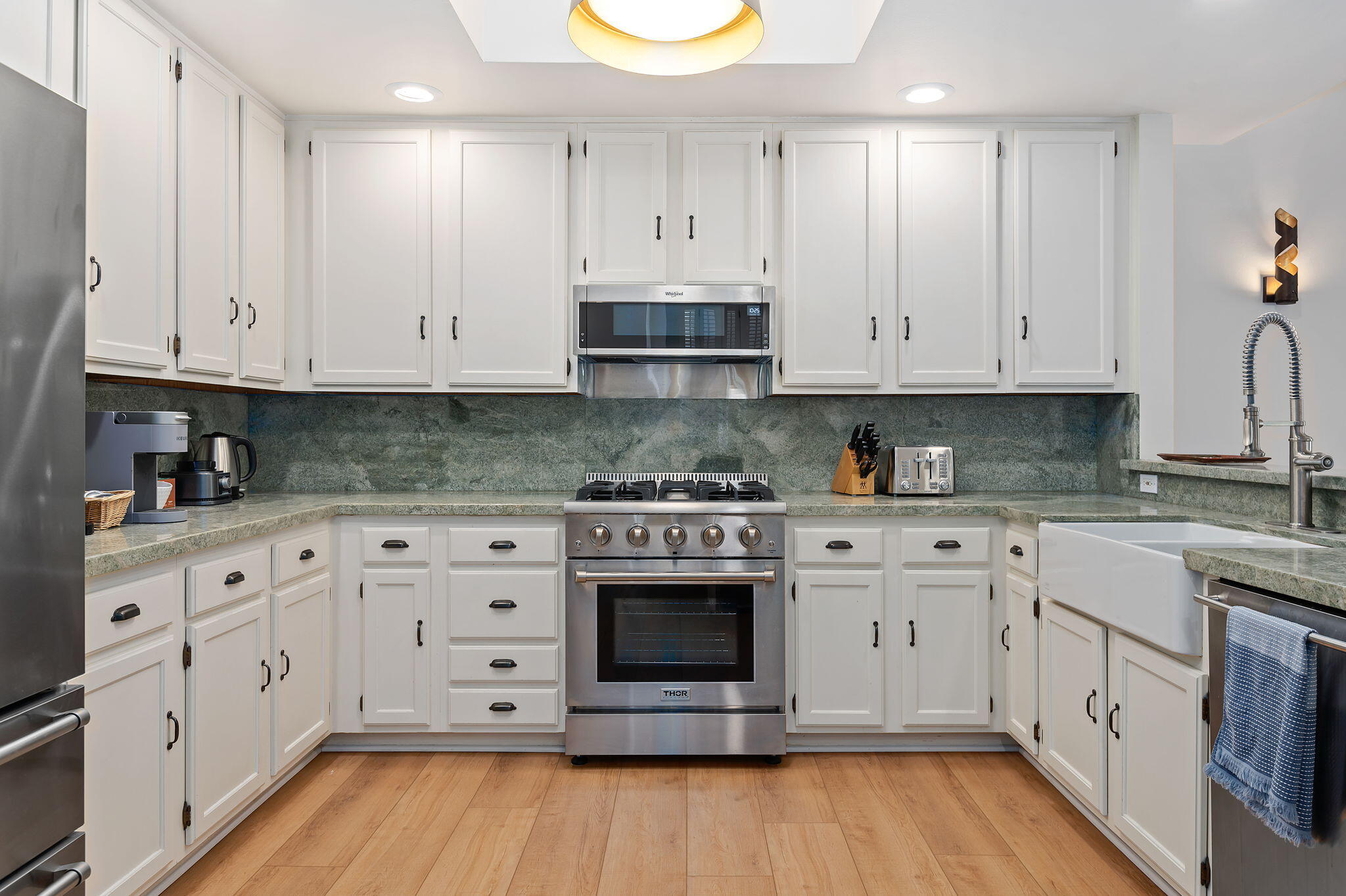 56 Olive Mill Road Santa Barbara, CA 93108 - Photo 11 of 28 a kitchen with stainless steel appliances granite countertop a stove a sink and white cabinets