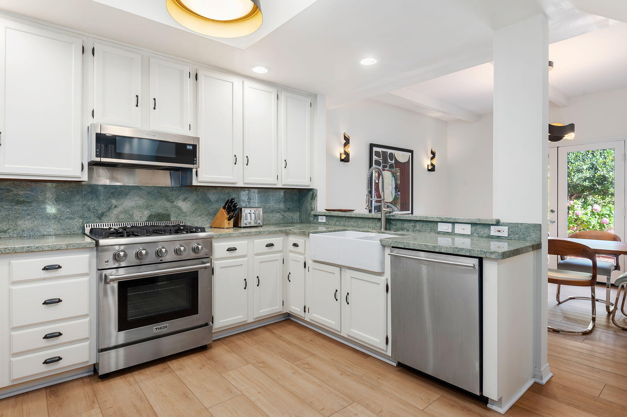56 Olive Mill Road Santa Barbara, CA 93108 - Photo 12 of 28 a kitchen with stainless steel appliances granite countertop a stove and white cabinets