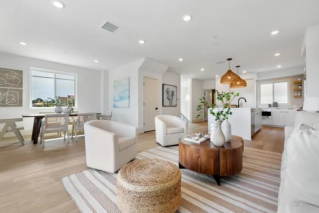 a living room with fireplace furniture and a wooden floor