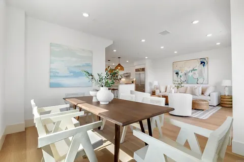 a dining room with furniture and wooden floor