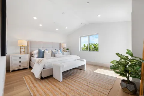 a bed room with bed and a potted plant