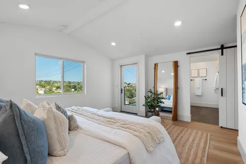 a bedroom with a bed and a large window