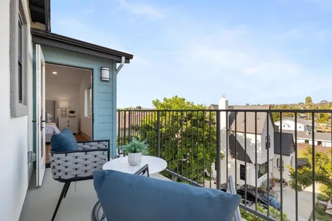 a view of a balcony with couches and wooden floor