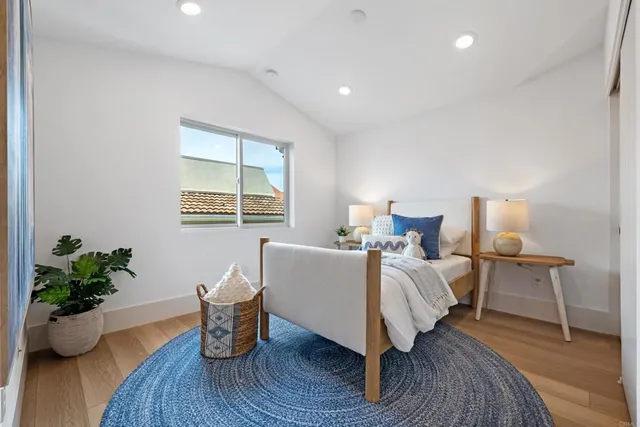 a bed room with a bed and a potted plant